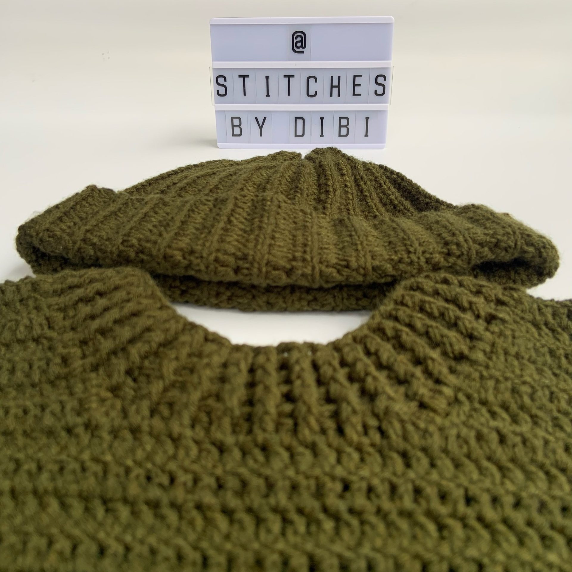 Chunky olive-green ribbed crochet beanie paired with a matching textured sweater